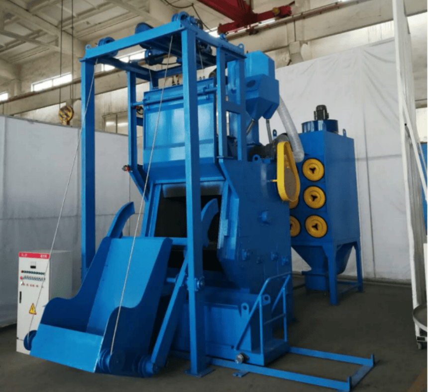 Industrial shot blasting machine with bucket elevator and dust collector system, designed for efficient surface cleaning and finishing in a workshop environment.
